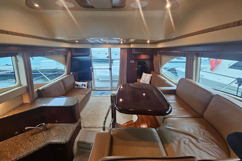 Slide: The Image of Luxurious interior of 2007 Sea Ray 44 Sedan Bridge yacht with spacious seating and elegant design. - 28