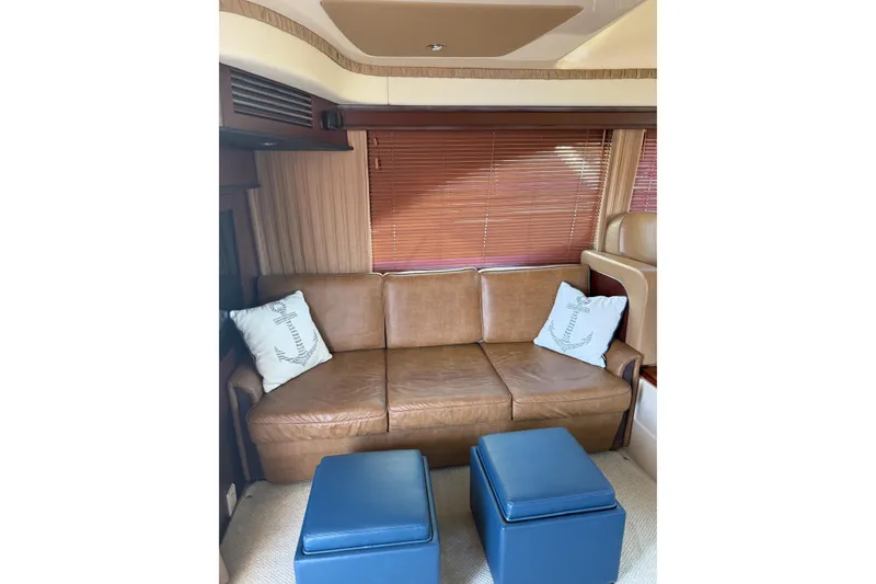 Slide: The Image of Luxurious interior of 2007 Sea Ray 44 Sedan Bridge with leather sofa and blue ottomans. - 29