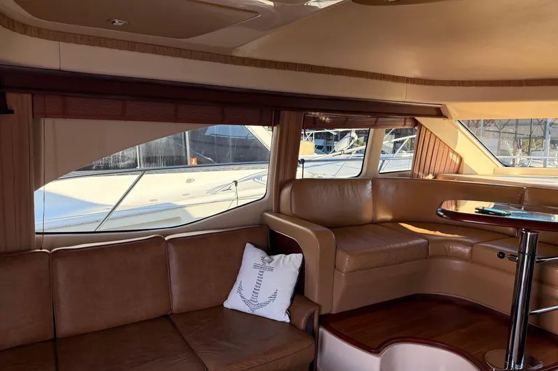 Slide: The Image of Interior of 2007 Sea Ray 44 Sedan Bridge with leather seating and large windows. - 30
