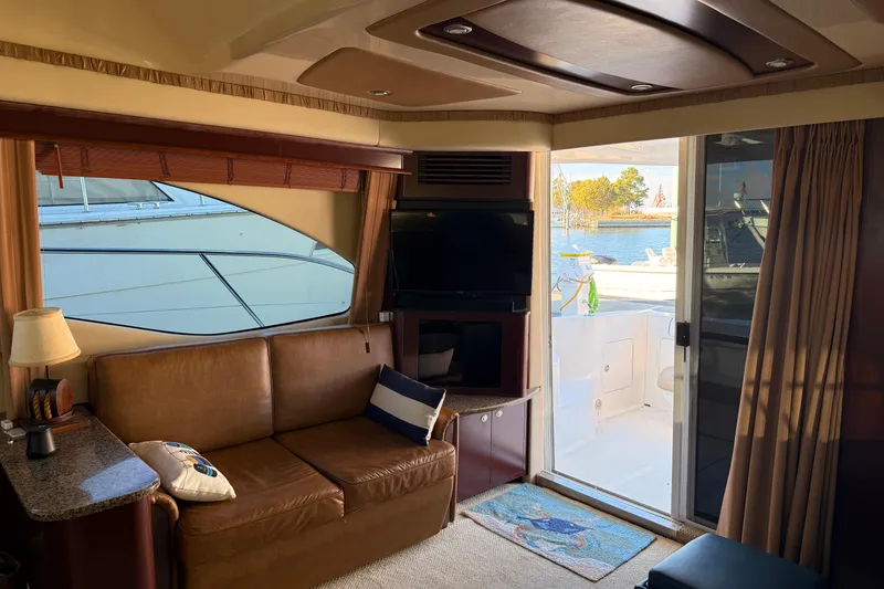 Slide: The Image of Interior of 2007 Sea Ray 44 Sedan Bridge yacht with leather seating and waterfront view. - 31