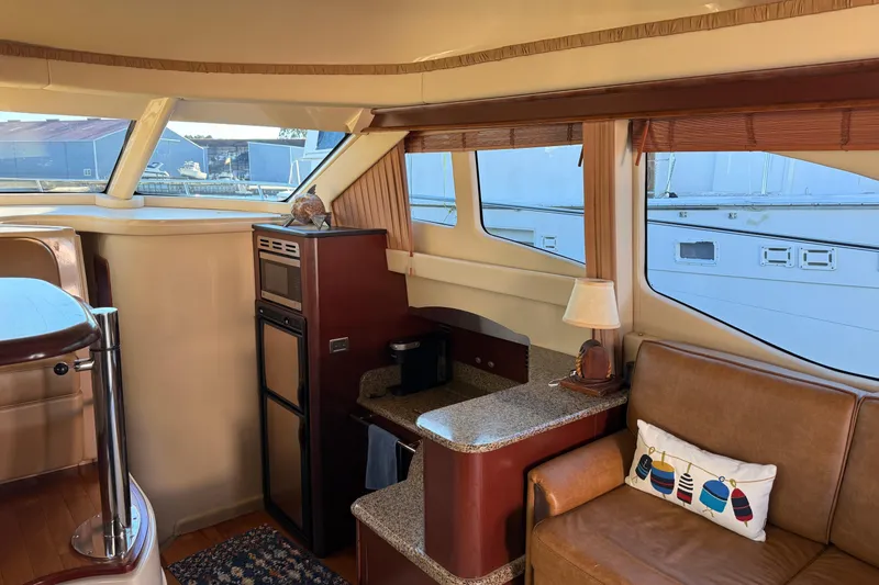 Slide: The Image of Interior of 2007 Sea Ray 44 Sedan Bridge yacht with cozy seating and kitchenette. - 34