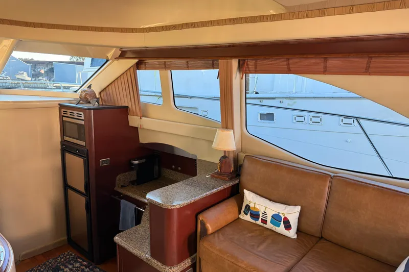 Slide: The Image of Interior of 2007 Sea Ray 44 Sedan Bridge yacht with cozy seating and kitchenette. - 35