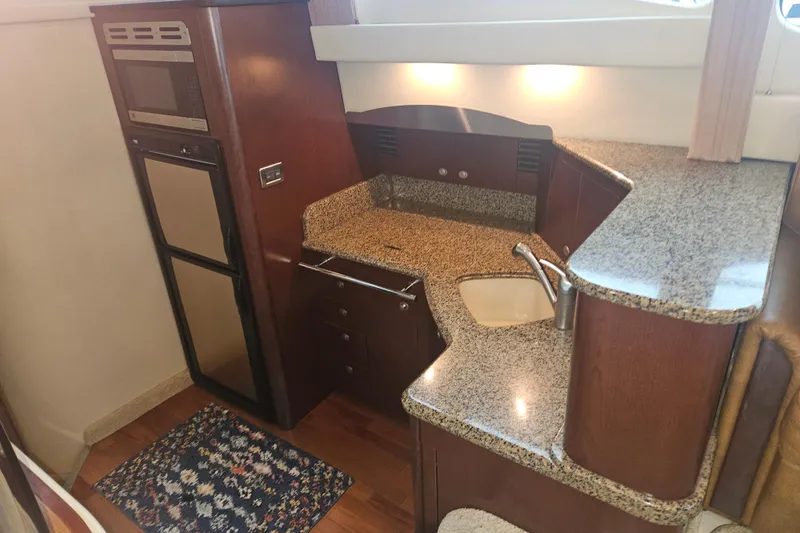 Slide: The Image of 2007 Sea Ray 44 Sedan Bridge kitchen with granite countertops and modern appliances. - 37