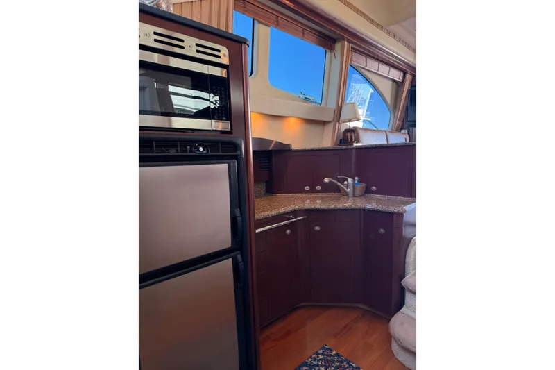 Slide: The Image of Luxurious kitchen interior of 2007 Sea Ray 44 Sedan Bridge yacht with modern appliances. - 38