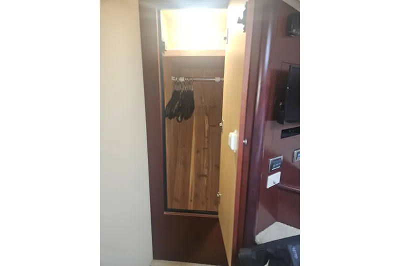 Slide: The Image of Open closet with hangers inside a 2007 Sea Ray 44 Sedan Bridge yacht interior. - 42