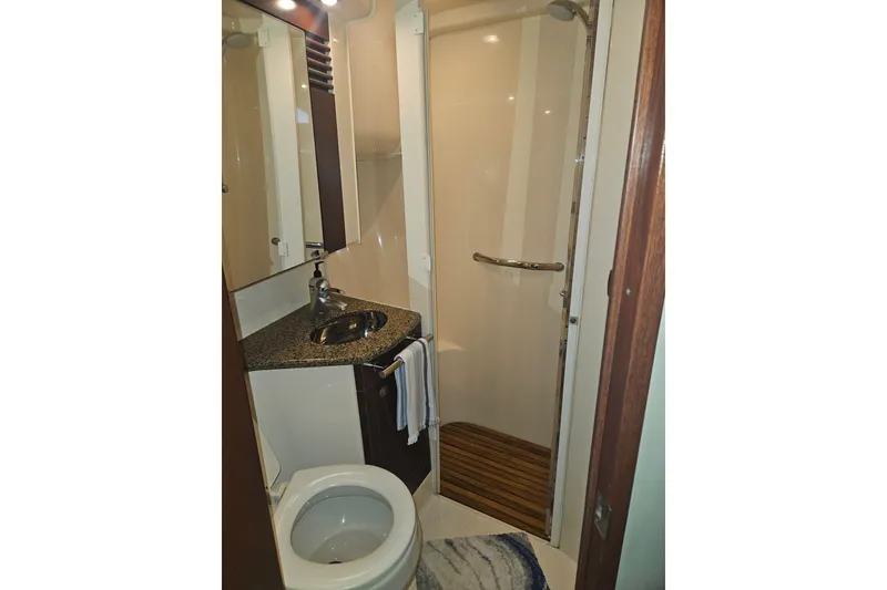 Slide: The Image of 2007 Sea Ray 44 Sedan Bridge bathroom with shower, sink, and toilet. - 45