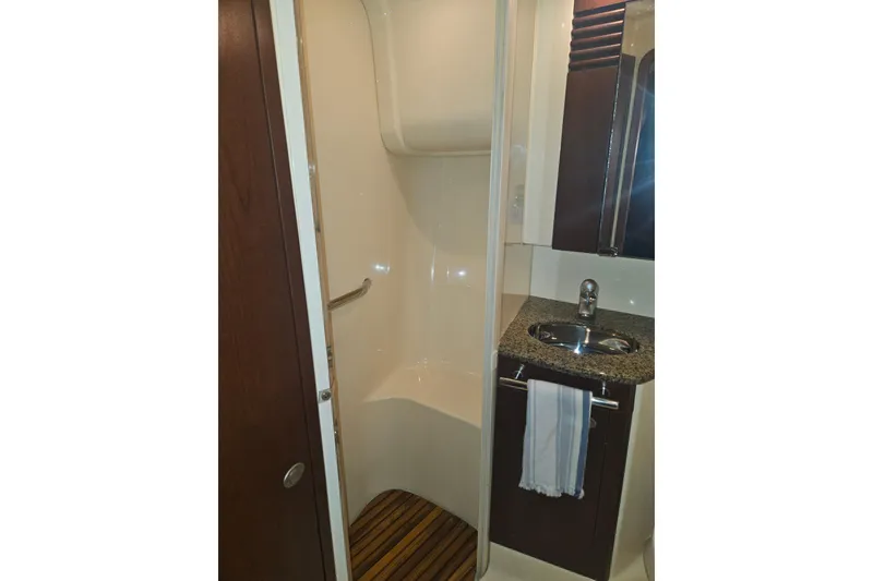 Slide: The Image of 2007 Sea Ray 44 Sedan Bridge bathroom with shower, sink, and wooden floor mat. - 47