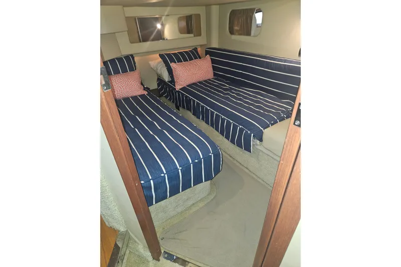 Slide: The Image of Interior cabin of 2007 Sea Ray 44 Sedan Bridge with striped bedding. - 48
