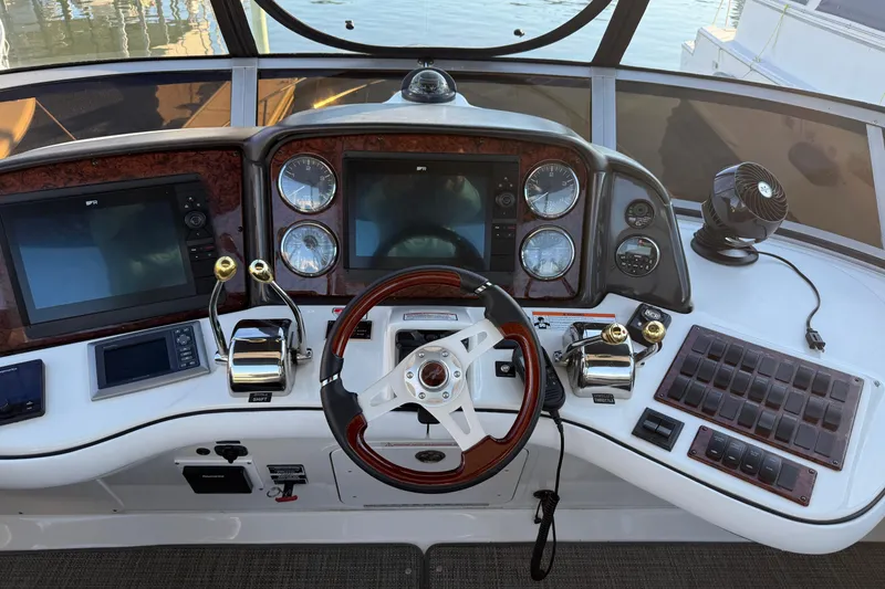 Slide: The Image of 2007 Sea Ray 44 Sedan Bridge helm with dual screens and controls. - 9