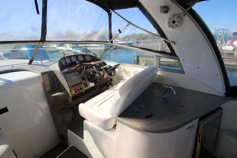 Slide: The Image of 2006 Rinker 320 Express Cruiser cockpit with steering wheel, dashboard, and sink. - 10
