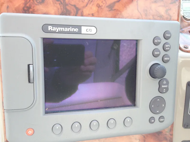 Slide: The Image of Raymarine C70 navigation system on 2006 Rinker 320 Express Cruiser dashboard. - 14