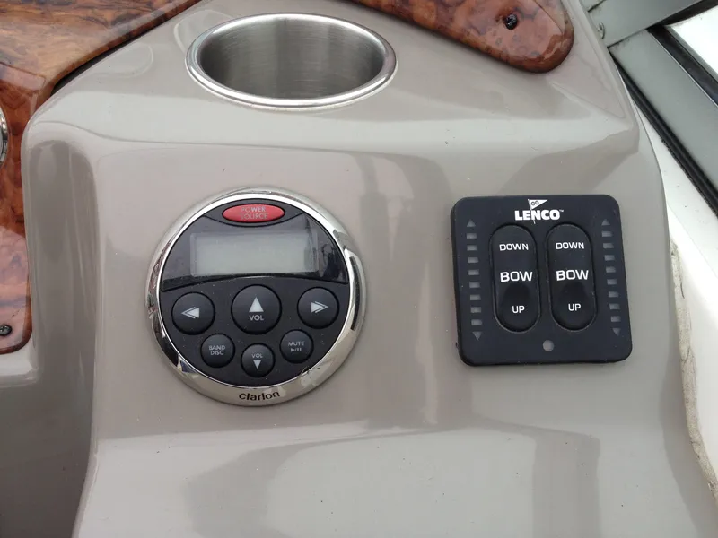 Slide: The Image of Control panel of 2006 Rinker 320 Express Cruiser with audio and trim tab controls. - 15