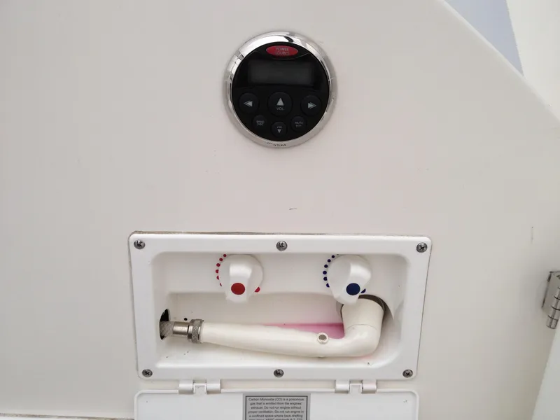 Slide: The Image of 2006 Rinker 320 Express Cruiser control panel and hose setup. - 19