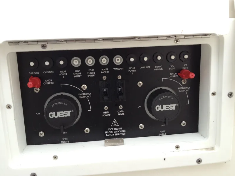 Slide: The Image of Control panel of a 2006 Rinker 320 Express Cruiser with various switches and dials. - 20
