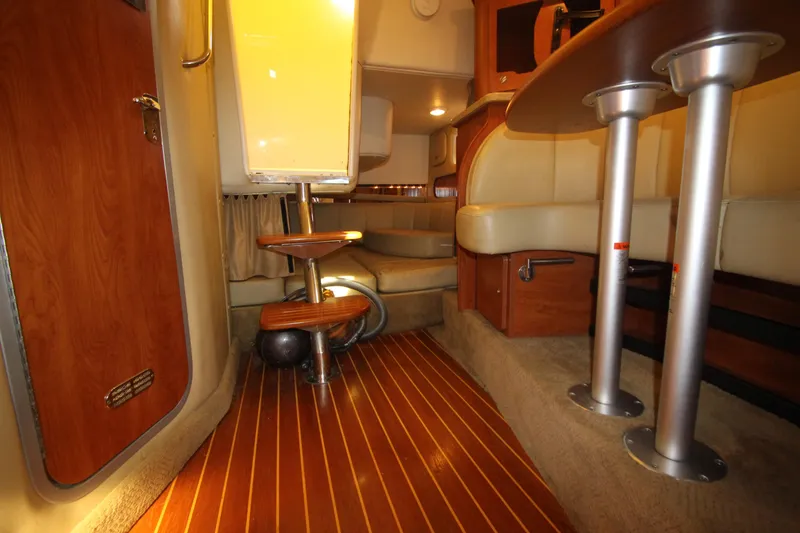 Slide: The Image of Interior of 2006 Rinker 320 Express Cruiser with wood flooring and beige seating. - 38