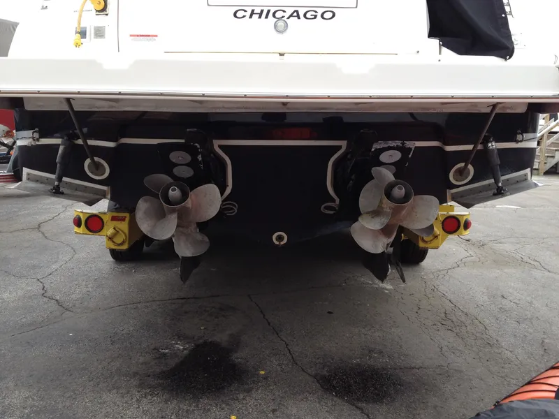 Slide: The Image of 2006 Rinker 320 Express Cruiser boat stern with dual propellers, docked in Chicago. - 40