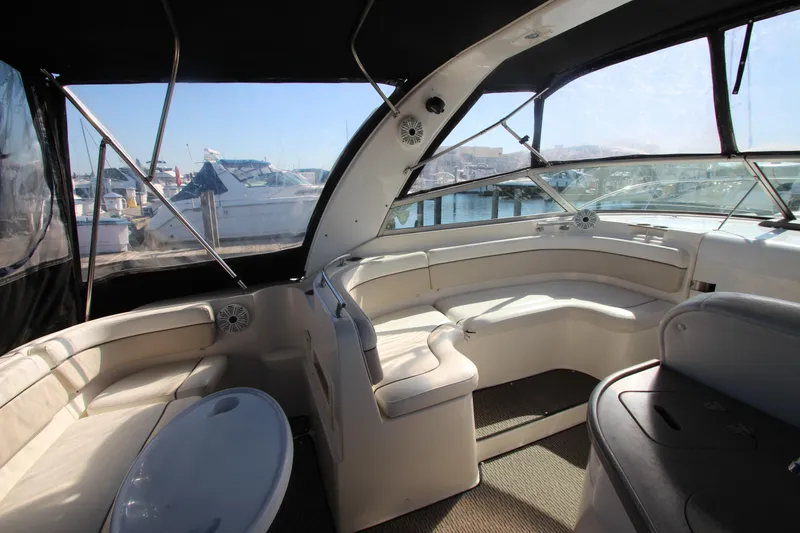 Slide: The Image of 2006 Rinker 320 Express Cruiser interior with seating and marina view. - 7