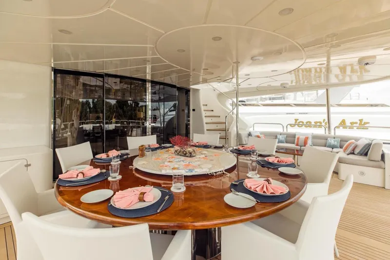 Slide: The Image of Luxurious dining area on 2007 Benetti 120 Classic yacht, elegantly set table with pink napkins. - 11