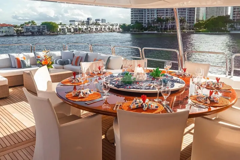 Slide: The Image of Luxurious dining setup on 2007 Benetti 120 Classic yacht, overlooking waterfront cityscape. - 13