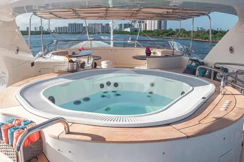 Slide: The Image of Luxurious Benetti 120 Classic yacht with jacuzzi, 2007 model, overlooking scenic waterfront skyline. - 21