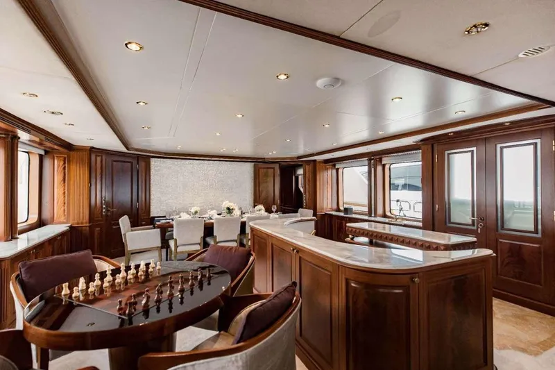 Slide: The Image of Luxurious interior of 2007 Benetti 120 Classic yacht with elegant wood finishes and chess table. - 24