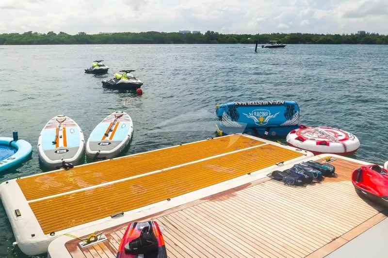 Slide: The Image of Water sports equipment on Benetti 120 Classic yacht deck, 2007 model, with jet skis and paddleboards. - 4