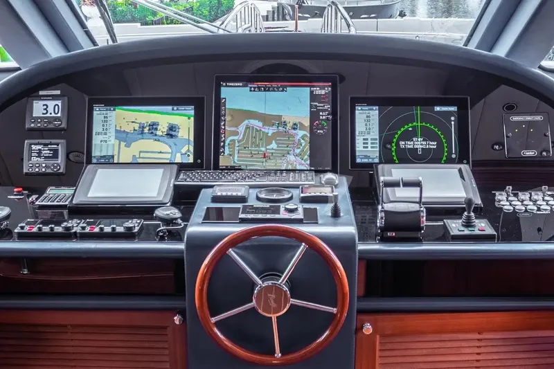 Slide: The Image of Control panel of a 2007 Benetti 120 Classic yacht with navigation screens and steering wheel. - 45