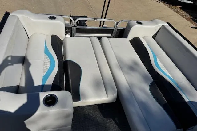 Slide: The Image of 2019 Qwest Edge 280 Cruise boat interior with white and black seating, blue accents. - 10