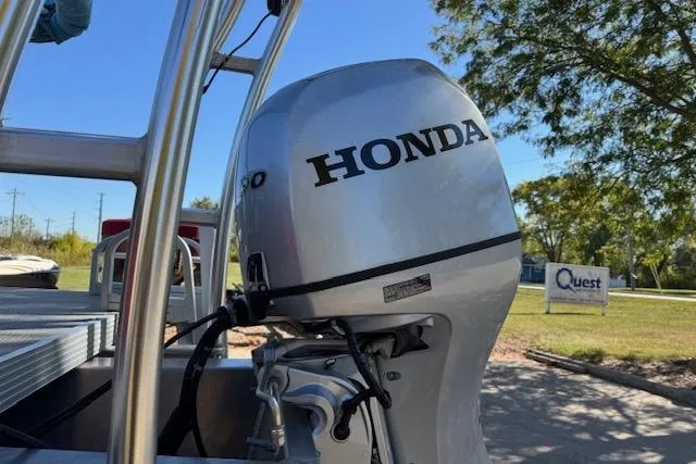 Slide: The Image of 2019 Qwest Edge 280 Cruise boat with Honda outboard motor in a sunny outdoor setting. - 12