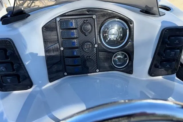 Slide: The Image of Dashboard of 2019 Qwest Edge 280 Cruise boat with gauges and controls. - 16