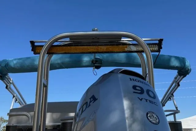 Slide: The Image of 2019 Qwest Edge 280 Cruise boat with Honda 90 VTEC engine, blue canopy, and stainless steel frame. - 20