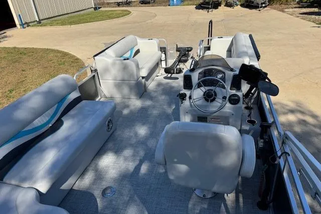 Slide: The Image of 2019 Qwest Edge 280 Cruise boat interior with seating and steering console. - 6