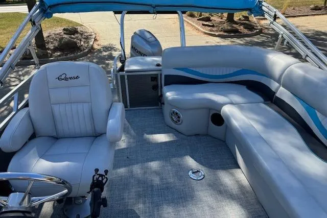 Slide: The Image of 2019 Qwest Edge 280 Cruise boat interior with seating and steering wheel. - 8