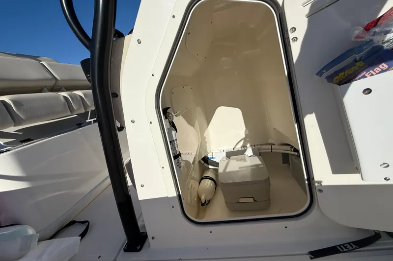 Slide: The Image of 2023 Boston Whaler 210 Montauk boat interior with storage compartment and seating. - 16