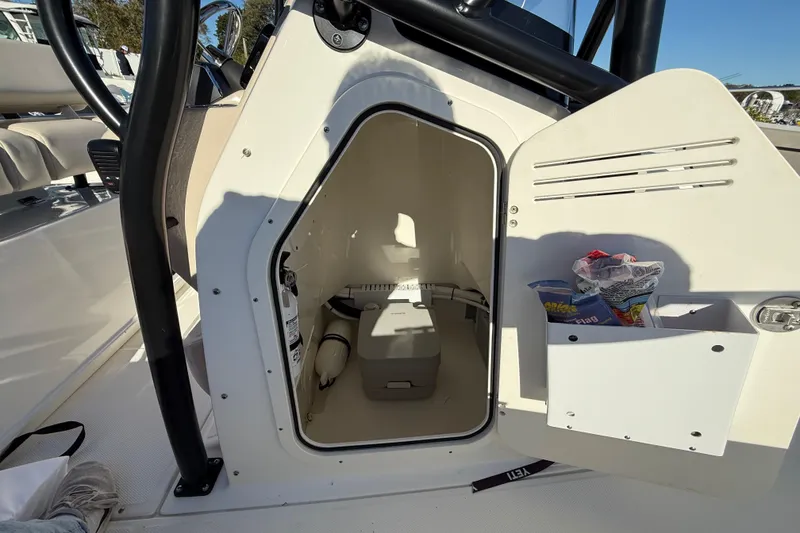 Slide: The Image of 2023 Boston Whaler 210 Montauk boat storage compartment with safety equipment and supplies. - 17