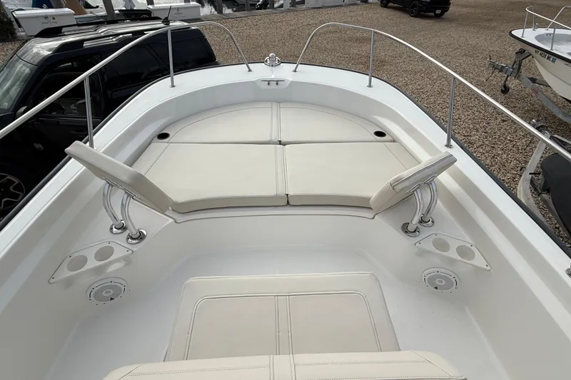 Slide: The Image of 2023 Boston Whaler 210 Montauk boat interior with cushioned seating and cup holders. - 20