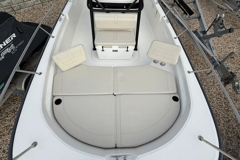 Slide: The Image of 2023 Boston Whaler 210 Montauk boat interior with cushioned seating and storage. - 22