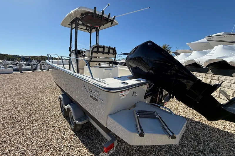 Slide: The Image of 2023 Boston Whaler 210 Montauk boat on trailer, featuring powerful outboard motor. - 3