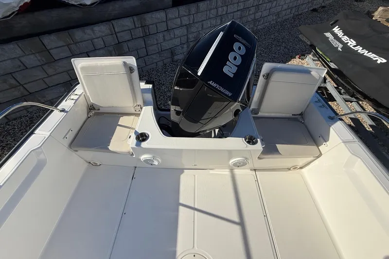 Slide: The Image of 2023 Boston Whaler 210 Montauk boat interior with Mercury engine and seating. - 7
