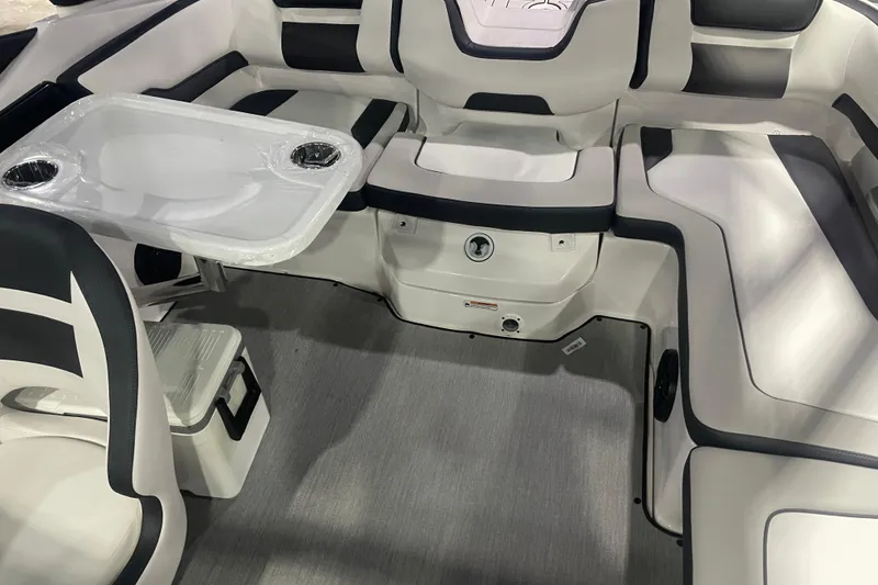 Slide: The Image of 2025 Yamaha Boats AR195 interior with seating and table, featuring modern design and cup holders. - 9