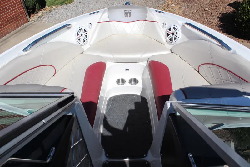 Slide: The Image of 2011 MasterCraft X-15 boat interior with white and red seating, cup holders, and speakers. - 13