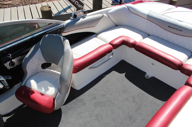 Slide: The Image of 2011 MasterCraft X-15 boat interior with red and white seating, dockside view. - 15