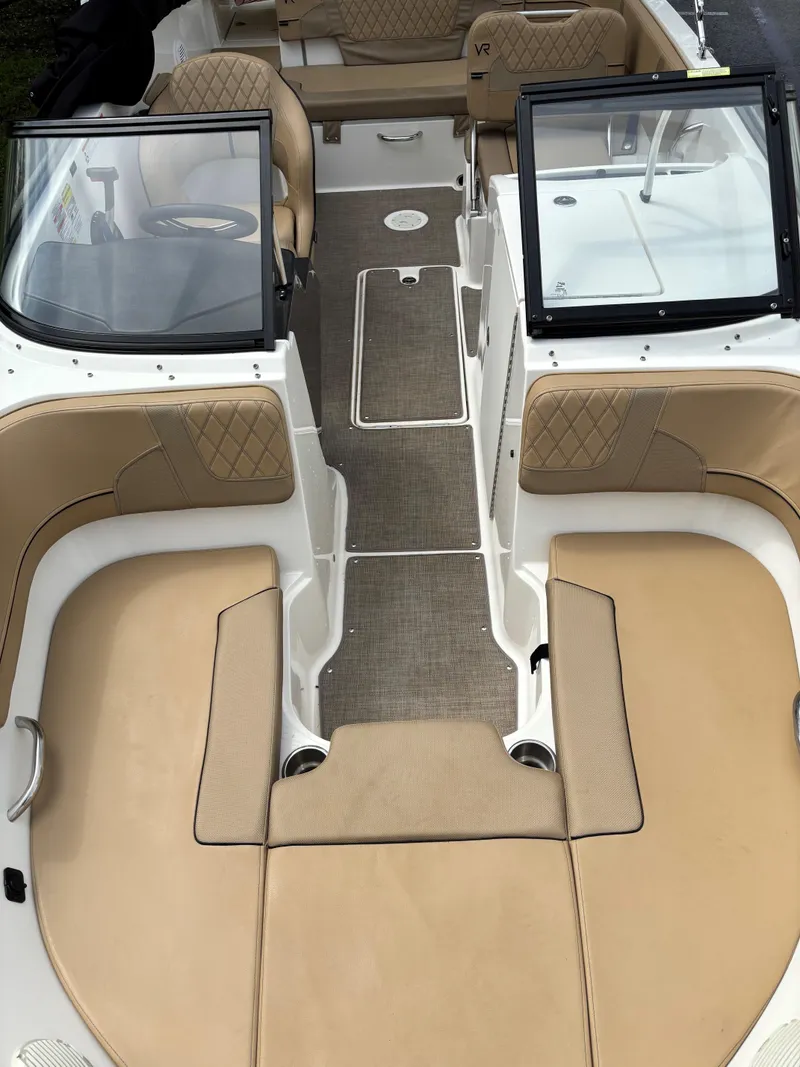 Slide: The Image of 2022 Bayliner VR6 Bowrider I/O interior with tan seating and open bow layout. - 3