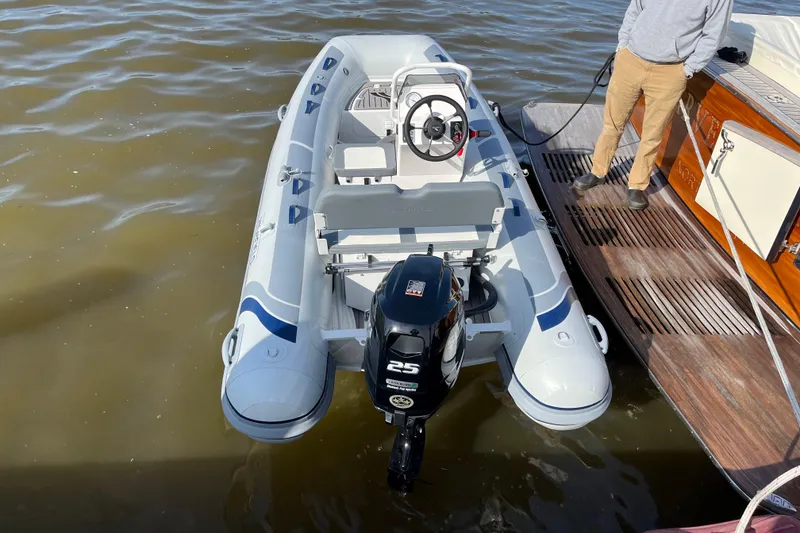 Slide: The Image of Inflatable boat with outboard motor docked beside a Vicem 52 Classic yacht, 2008 model. - 5