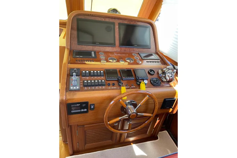 Slide: The Image of Helm of 2008 Vicem 52 Classic yacht with wooden dashboard and navigation screens. - 6