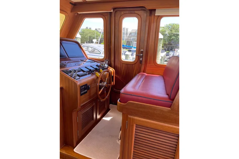 Slide: The Image of 2008 Vicem 52 Classic yacht interior with wooden helm and red seating. - 7