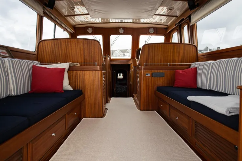 Slide: The Image of Interior of 2008 Vicem 52 Classic yacht with wooden finish and striped seating. - 8