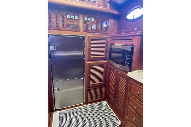 Slide: The Image of Interior of 2008 Vicem 52 Classic yacht with wooden cabinetry and stainless steel appliances. - 9