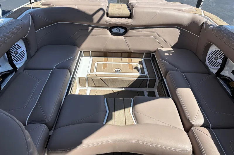 Slide: The Image of 2026 Centurion Ri230 boat interior with brown leather seating and modern design. - 13