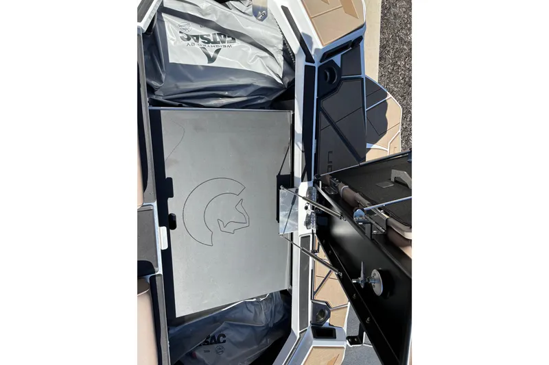 Slide: The Image of 2026 Centurion Ri230 boat storage compartment with ballast bags and sleek design. - 17